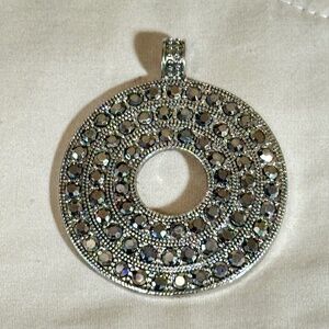 Silver tone, large round pendant. 3 rows-round clear rhinestones-Open center